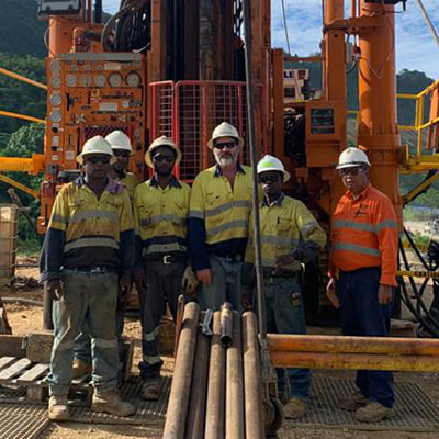 Zenex Drilling team in front of mine drilling machinery in Papua New Guinea